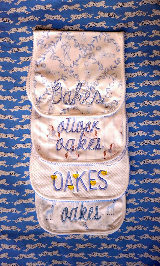 John Oliver Designs - 4 burp cloths stacked, different embroidery styles