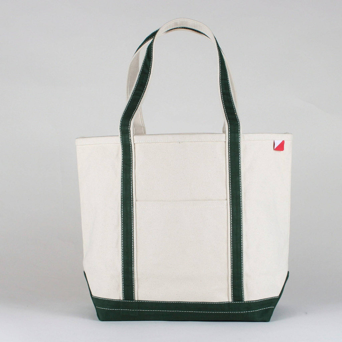 Personalized canvas tote in natural cream canvas with Hunter Green trim, embroidered in San Antonio