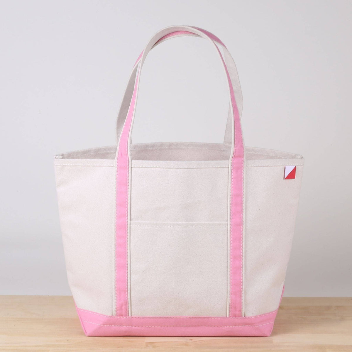 Personalized canvas tote in natural cream canvas with Light Pink trim, embroidered in San Antonio